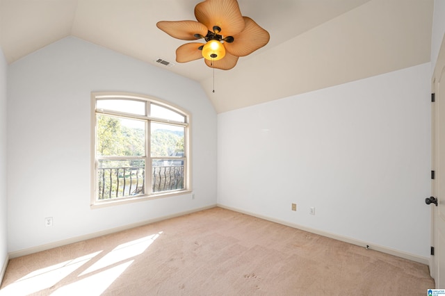 carpeted empty room with ceiling fan and vaulted ceiling