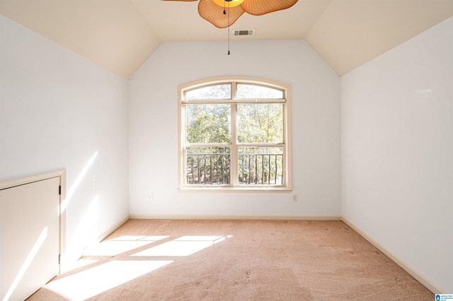 spare room with ceiling fan, light colored carpet, and lofted ceiling