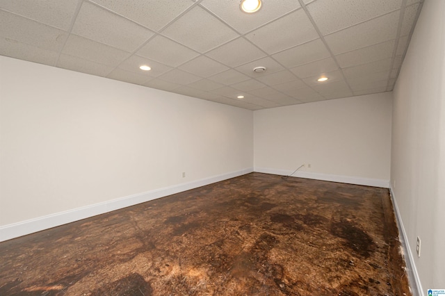 carpeted empty room featuring a paneled ceiling