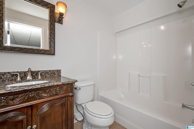 full bathroom featuring tile patterned flooring, vanity,  shower combination, and toilet