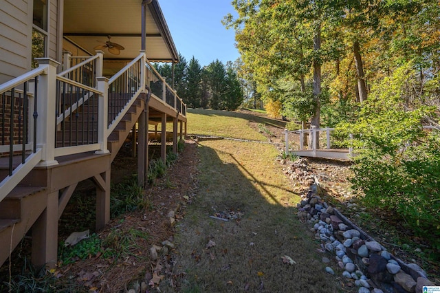 view of yard featuring ceiling fan and a wooden deck