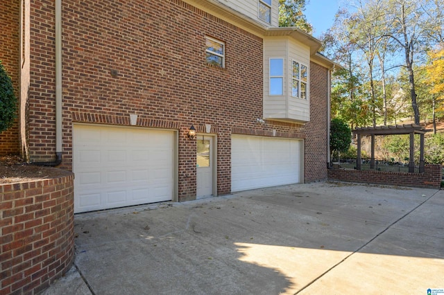 view of home's exterior featuring a pergola and a garage