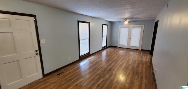 entryway with french doors, hardwood / wood-style floors, ceiling fan, and a textured ceiling