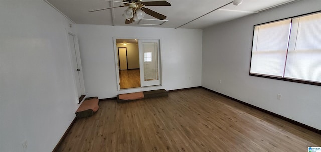 401 Park St E, Sylacauga, AL 35150 - spare room featuring wood finished floors, a ceiling fan, and baseboards