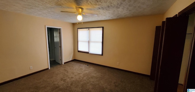 unfurnished bedroom featuring a textured ceiling, carpet floors, and ceiling fan