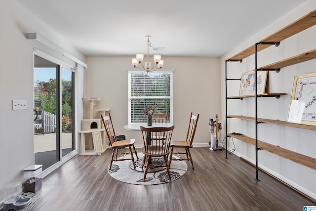 dining room featuring dark wood-type flooring and a notable chandelier