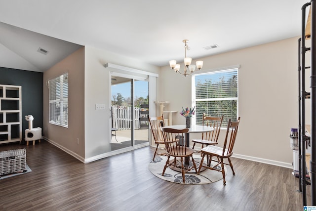 dining room with lofted ceiling, a chandelier, and dark hardwood / wood-style flooring