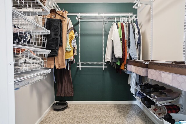 walk in closet featuring carpet