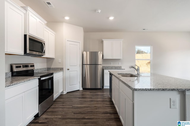 kitchen with dark wood-type flooring, sink, a center island with sink, appliances with stainless steel finishes, and white cabinets