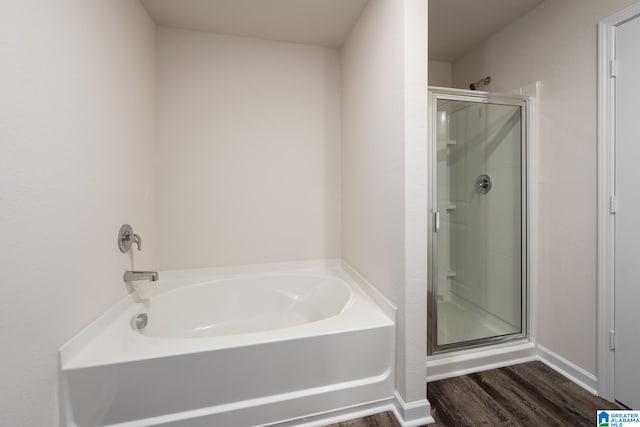 bathroom with hardwood / wood-style flooring and independent shower and bath