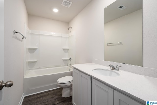 full bathroom with wood-type flooring, bathing tub / shower combination, vanity, and toilet