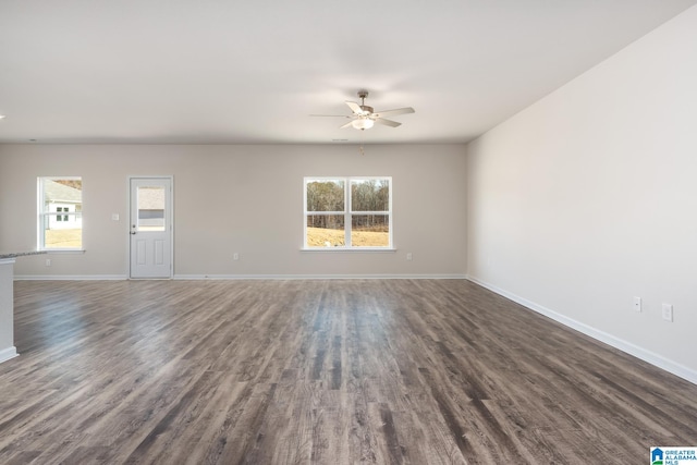 empty room featuring ceiling fan and dark hardwood / wood-style flooring