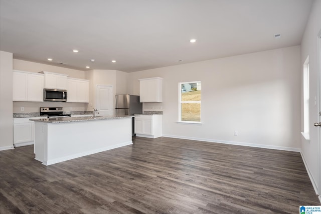 kitchen with a center island with sink, dark hardwood / wood-style floors, white cabinets, and appliances with stainless steel finishes