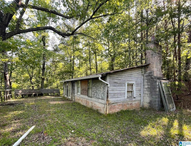 view of property exterior featuring a lawn