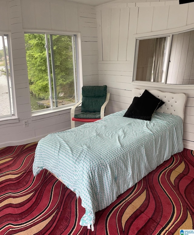 bedroom with wood walls