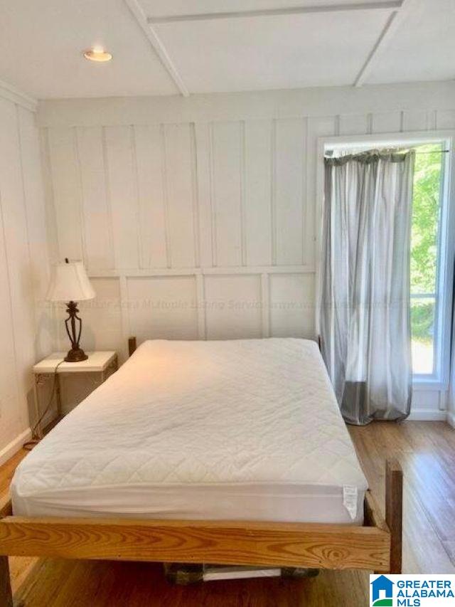 bedroom with wood-type flooring