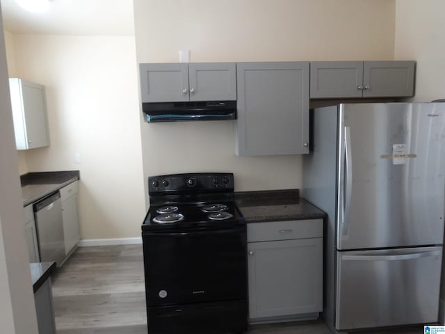 kitchen featuring stainless steel appliances, gray cabinets, and light hardwood / wood-style floors