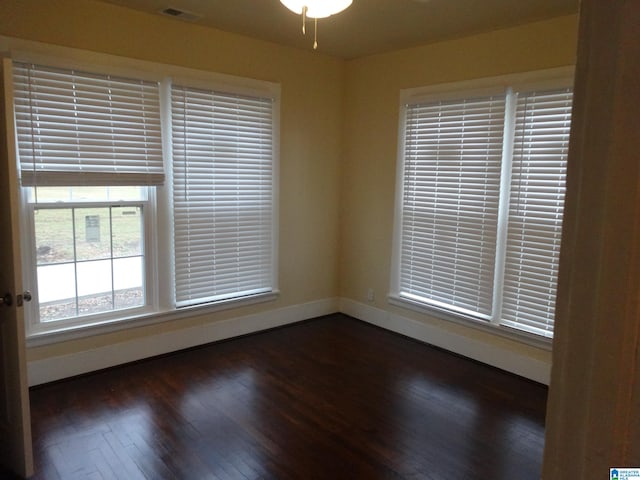 empty room featuring ceiling fan and dark hardwood / wood-style floors