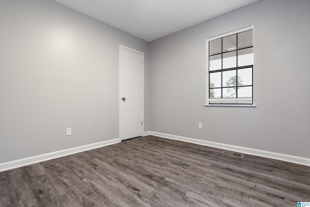 spare room with dark wood-type flooring