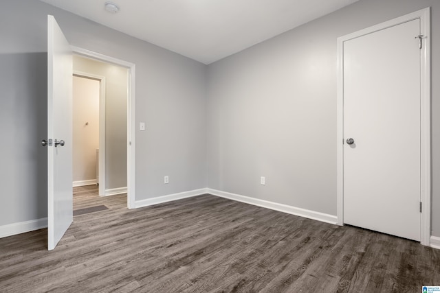 unfurnished room featuring dark hardwood / wood-style flooring