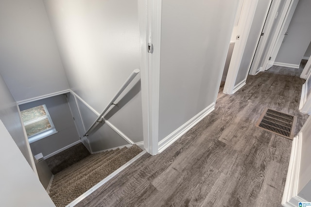 stairway featuring wood-type flooring