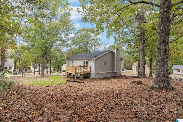 back of house featuring a wooden deck