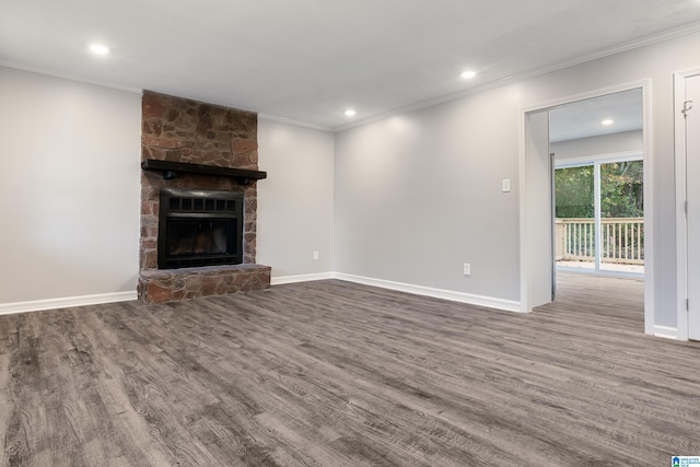 unfurnished living room featuring a fireplace, hardwood / wood-style floors, and ornamental molding