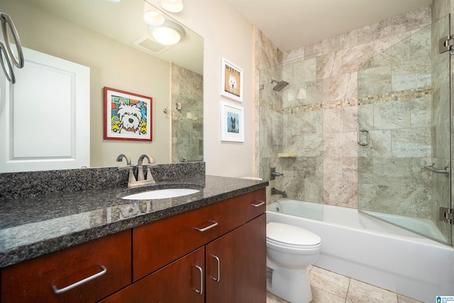 full bathroom with toilet, vanity, bath / shower combo with glass door, and tile patterned flooring