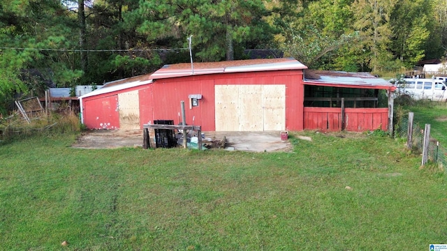 view of outbuilding featuring a yard