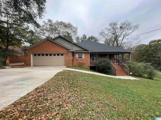 view of front facade featuring a garage, a porch, and a front yard