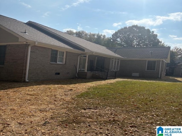 rear view of property with a yard