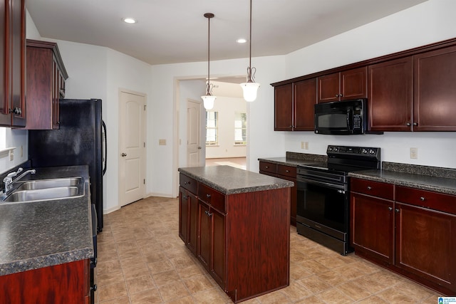 kitchen featuring black appliances, a kitchen island, pendant lighting, and sink