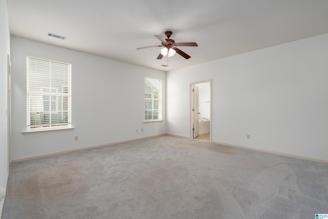 spare room with light carpet and ceiling fan