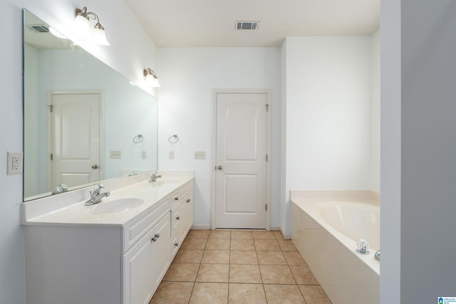 bathroom with vanity, tiled bath, and tile patterned floors