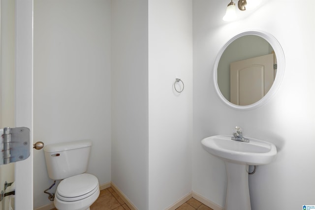 bathroom with toilet and tile patterned flooring