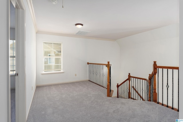 empty room with carpet flooring and ornamental molding