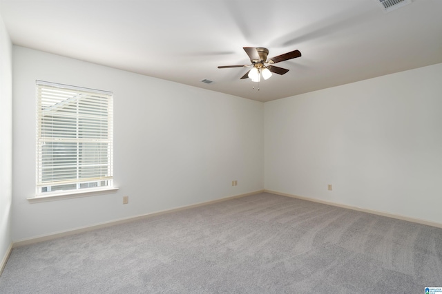 carpeted empty room featuring plenty of natural light and ceiling fan