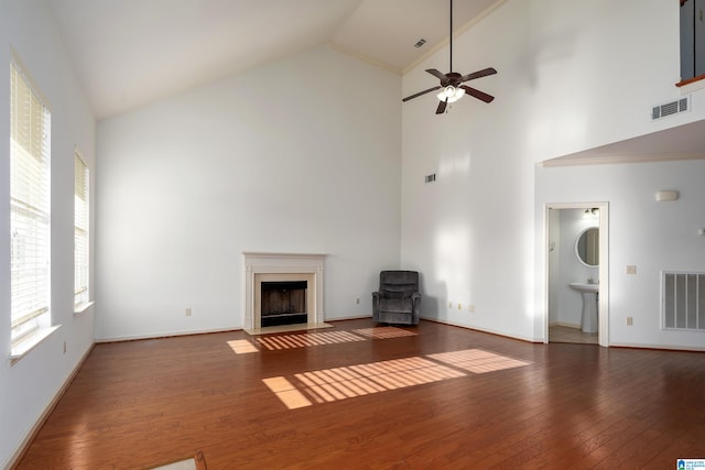 unfurnished living room featuring high vaulted ceiling, dark hardwood / wood-style flooring, sink, and ceiling fan