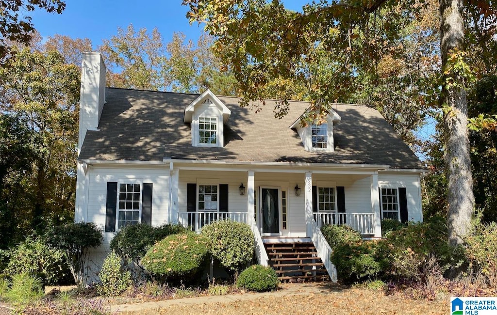 cape cod-style house featuring a porch