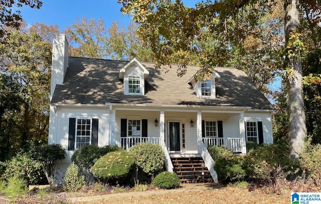 new england style home with a porch