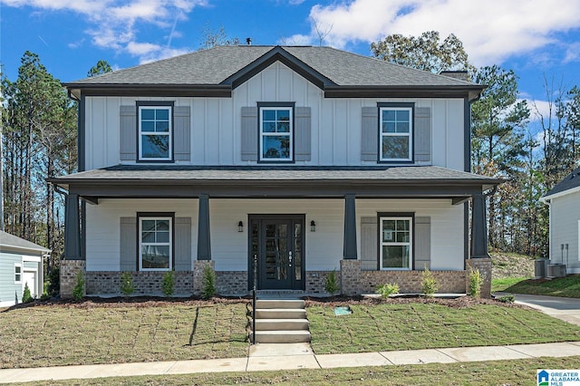 view of front of house featuring central AC, a front lawn, and covered porch