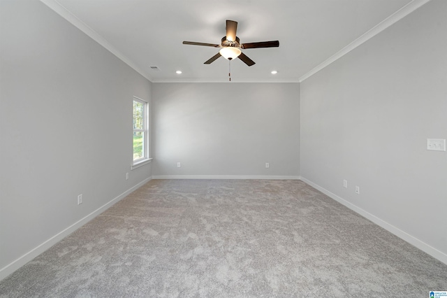 spare room with light carpet, crown molding, and ceiling fan