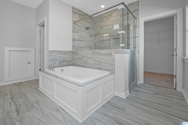 bathroom featuring independent shower and bath