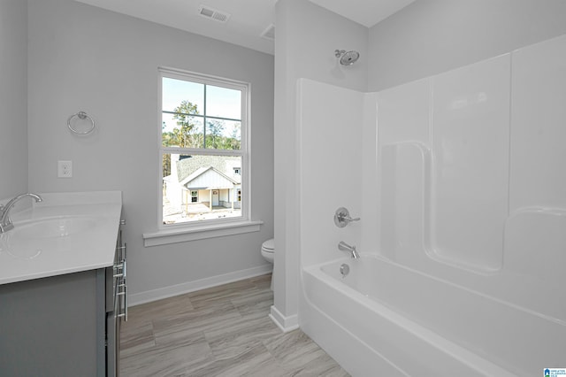 full bathroom with vanity, shower / tub combination, and toilet