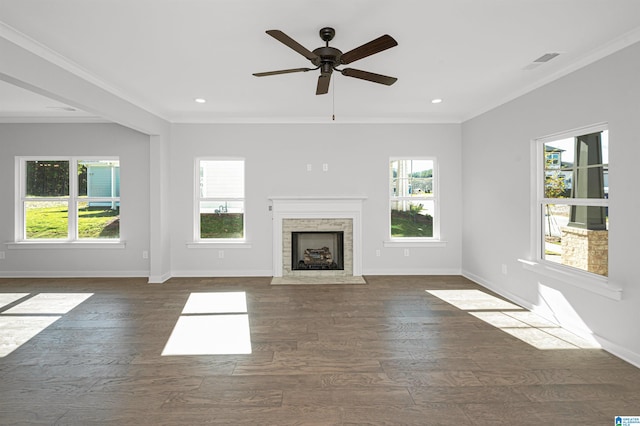 unfurnished living room featuring dark hardwood / wood-style floors, plenty of natural light, and ornamental molding