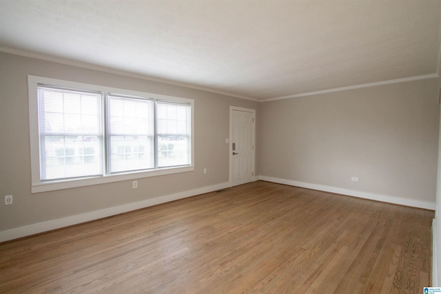 unfurnished room featuring light wood-type flooring and crown molding