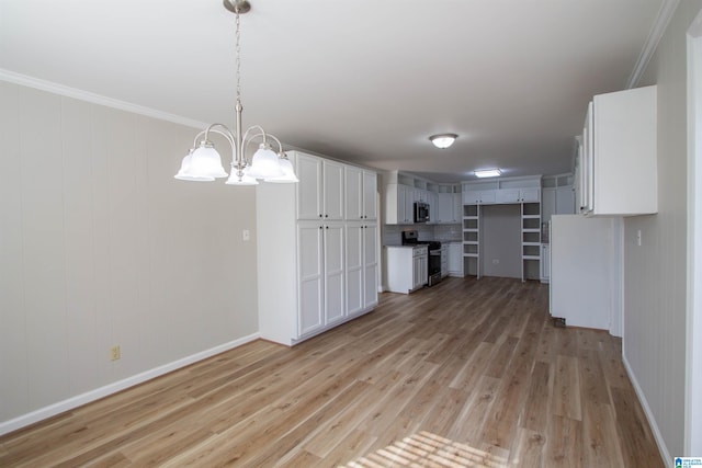 kitchen with light hardwood / wood-style flooring, appliances with stainless steel finishes, ornamental molding, and white cabinets