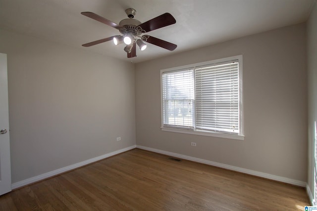 empty room featuring ceiling fan and wood-type flooring