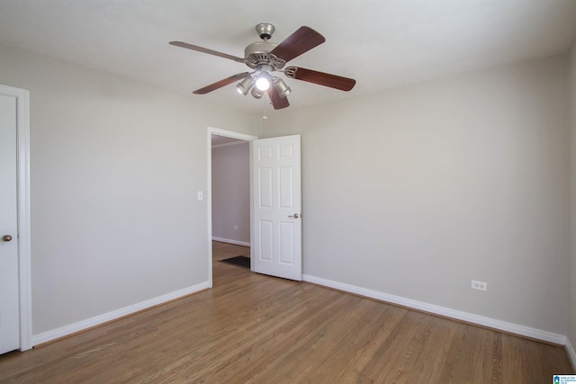 spare room with hardwood / wood-style flooring and ceiling fan