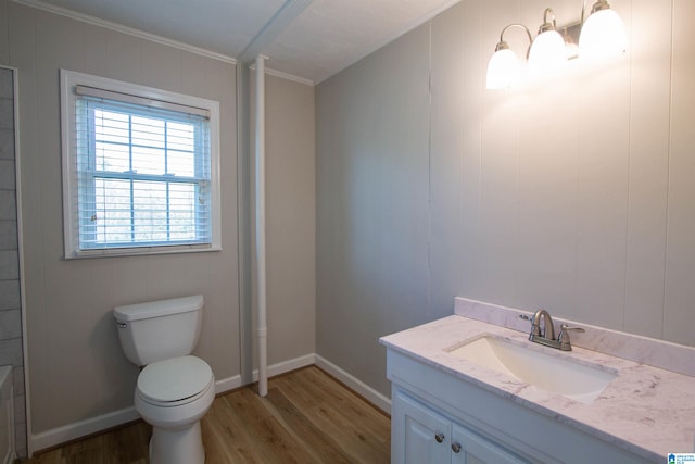 bathroom with hardwood / wood-style flooring, vanity, toilet, and ornamental molding